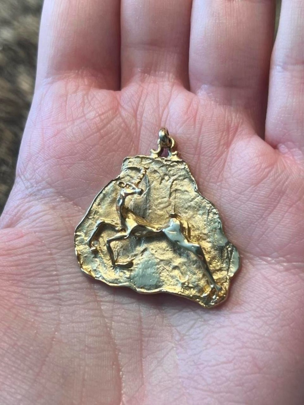 Gold toned Aries/antelope brutalist artisan pendant